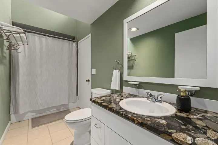 The full bathroom supports both bedrooms upstairs. The vanity is well-appointed.