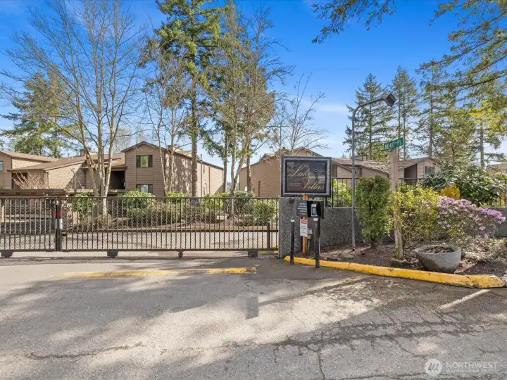 Gated entry to Lake Villas community with security gate and signage