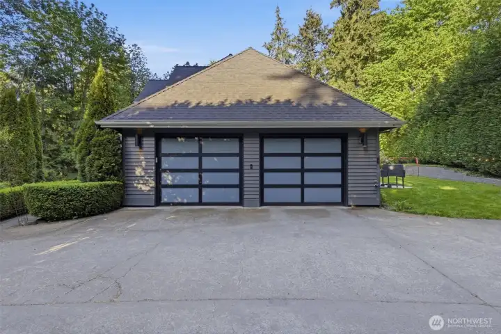 Finished 2-car garage with epoxy flooring, fresh paint, and upgraded lighting