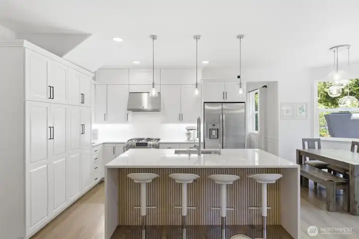 Updated kitchen with refreshed countertops, fixtures, and modern lighting