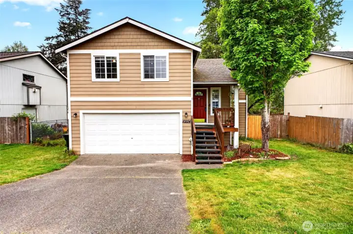 Front view of well cared for 4 bed home on large lot ready for new buyers