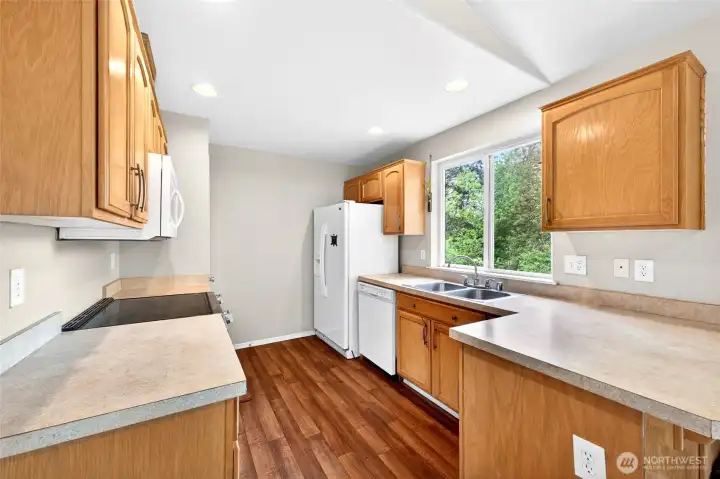 Updated kitchen with lots of counter top space and cabinets with recessed lighting
