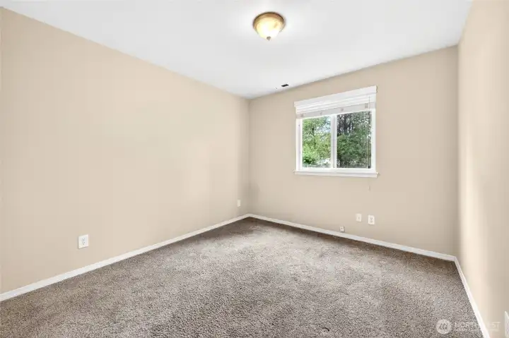 Lower level bedroom view with window looking out to back yard