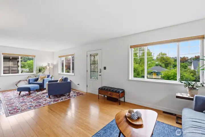 Large living room with two distinct gathering spaces provides flexibility for relaxing and entertaining.
