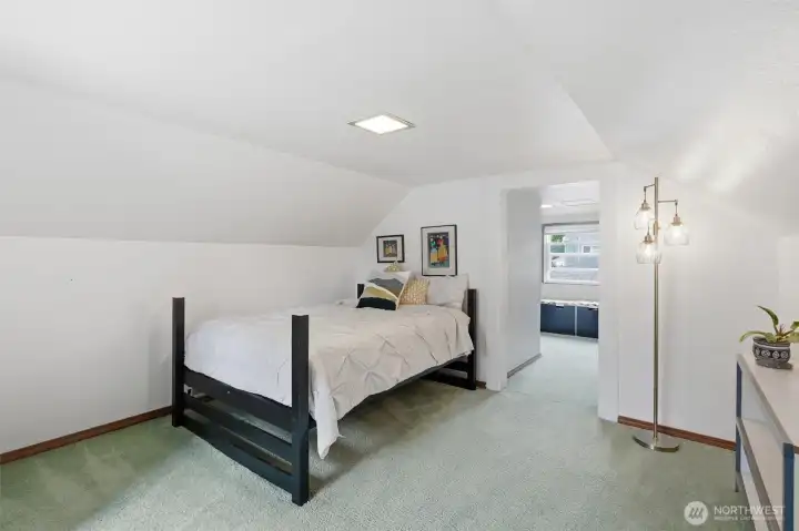 Cozy attic bedroom filled with character and a tucked-away retreat feel.