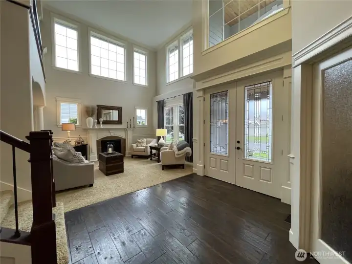 THE GRAND ENTRY with the LIVING ROOM in the BACKGROUND & a small PEAK at the #1 STAIRCASE
