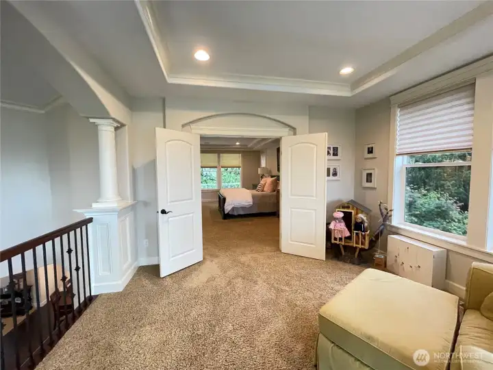 STANDING in SITTING ROOM LOOKING thru DBL DOORS at GRAND SUITE & REAR YARD & COVERED BALCONY + SIDE YARD WINDOW to the RIGHT