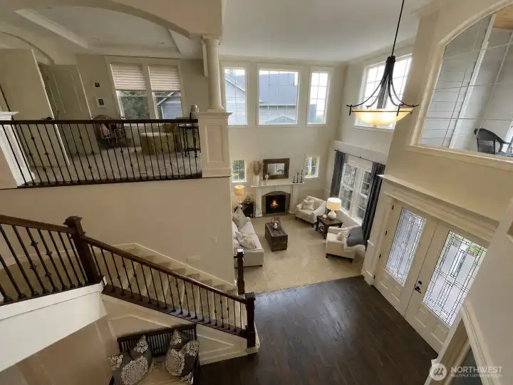 STANDING at 2ND STORY OPEN RAILING LOOKING at #1 STAIRCASE SITTING RM, LIVING RM & GRAND ENTRY