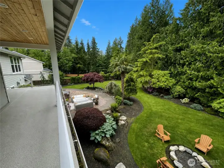 STANDING on GRAND SUITE COVERED DECK LOOKING SW AT REAR YARD, FIRE PIT & GAS FIRE PIT ON PATIO