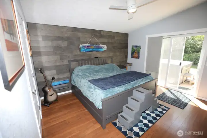 Large primary bedroom with walk-in closet and slider to the back deck.
