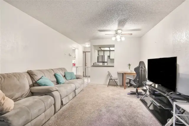 The living area flows seamless into the dining area with a pass-thru to the kitchen.