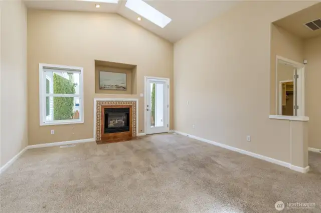 Family room has gas fireplace, bright skylights