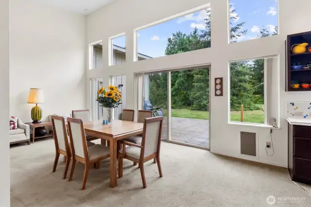 Formal dining area with large windows and natural light