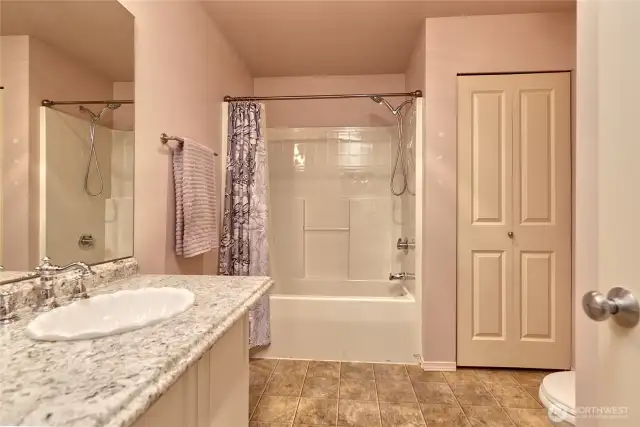 Roomy guest bathroom with a  convenient linen closet