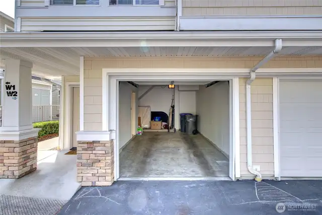 Over sized garage with extra storage area leading under the stairs as well