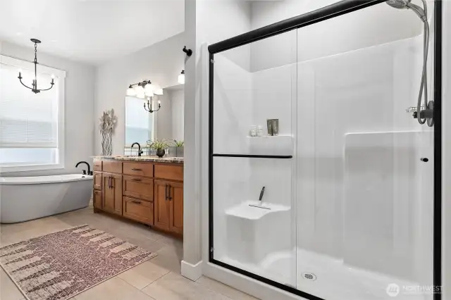 Great size walk-in shower and a large free-standing tub w/large window complete this dreamy ensuite bathroom