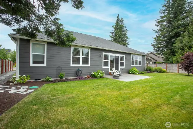 Meticulous mostly fenced backyard w/stamped patio