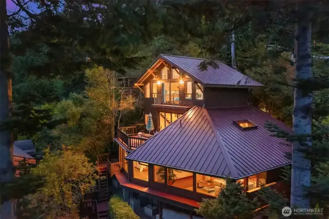 This drone shot captures the west side of the home which faces the sounds. All the rooms in this house have stunning views.