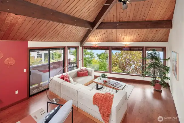 The sunken living room is very large but somehow the wood vaulted ceilings keep things feeling cozy.
