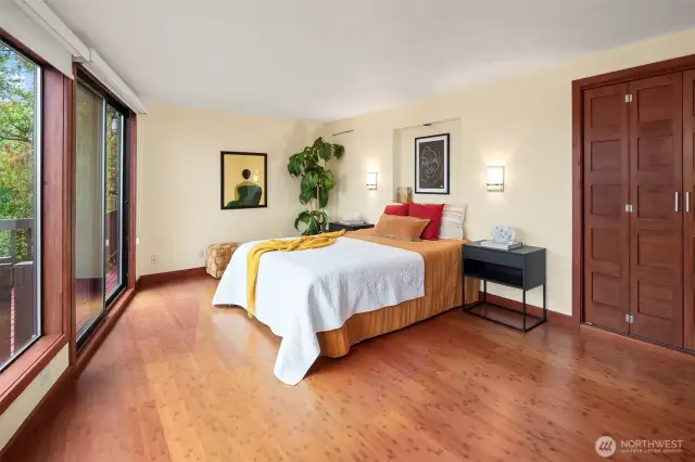 Secondary suite is spacious with stunning views and a gorgeous bathroom. Beyond the doors is the laundry and the unfinished basement space.