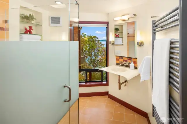 Beautiful bathroom with towel warmer and colorful design.