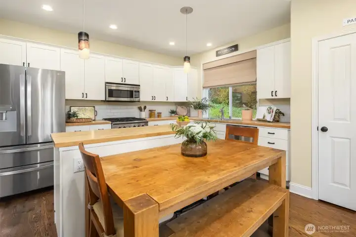 This large kitchen features both a walk-in pantry and ample eat-in space.