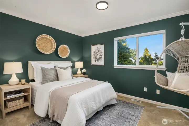 This back upper floor bedroom showcases views of the Cascades, Mt. Rainier and Lake Washington.