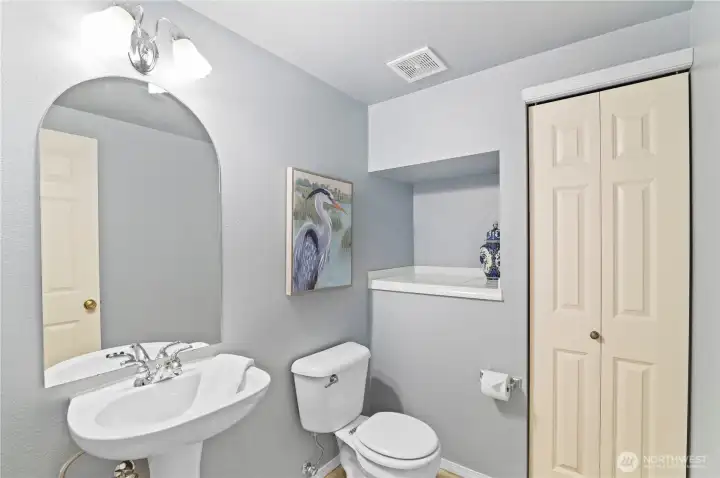 Large powder room on main floor, with large storage closet.