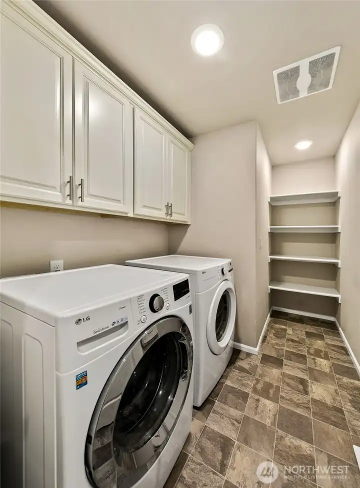 Large laundry room with plenty of storage.