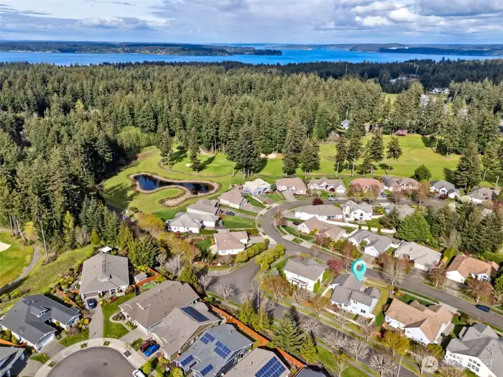 Just beyond the home, you’ve got The Golf Club at Hawks Prairie stretching through the neighborhood, beautifully maintained fairways, mature landscaping, and a layout that winds naturally through the community instead of cutting it off. This is a 36-hole facility with two distinct courses, The Links and The Woodlands, offering everything from wide-open play to more technical, tree-lined challenges. You’re close enough to enjoy the views, the greenery, and that elevated neighborhood feel, without being right on top of it worrying about stray golf balls interrupting your day. Then just beyond it all, you catch that glimpse of the Nisqually Reach, adding depth, light, and a little bit of wow to the entire scene.