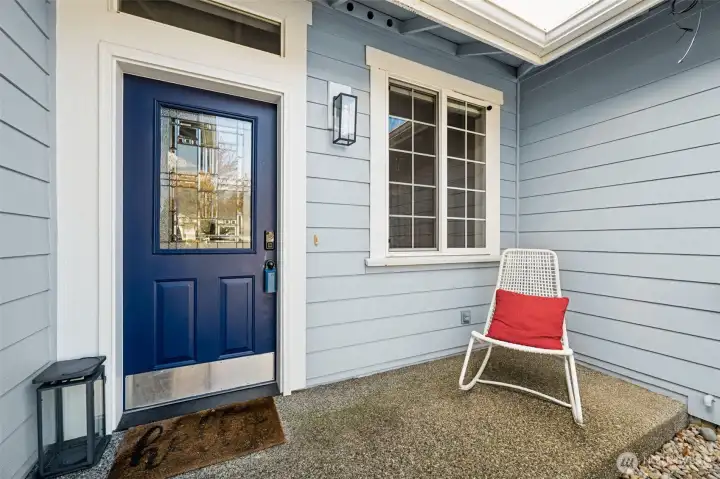 The front door features a leaded glass insert that brings in just the right amount of classic charm, catching the light and setting the tone before you even step inside. Above it, that accent window lifts the entire entry, adding height and a little drama in the best way. There’s space to the side for a chair or a seasonal moment. The aggregate concrete porch keeps everything grounded and polished, while that nearby window with its grid detail adds another layer of character. And if that front-facing bedroom becomes an office, you’ve got the perfect vantage point to keep an eye on arrivals without ever leaving your desk.