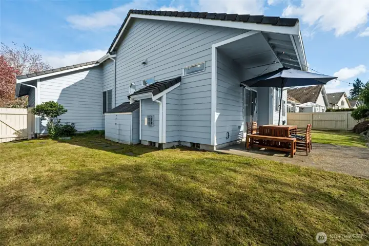 A partially covered patio gives you the flexibility to stay out a little longer, whether it’s a sunny afternoon or a drizzly Northwest evening. There’s a built-in side shed already in place, perfect for stashing tools, gear, or anything you don’t want crowding the garage. The lawn is level and wide open, which means gardens, games, lounging setups, all on the table. And with a sprinkler system running in both the front and backyard, keeping everything green doesn’t turn into a full-time job.