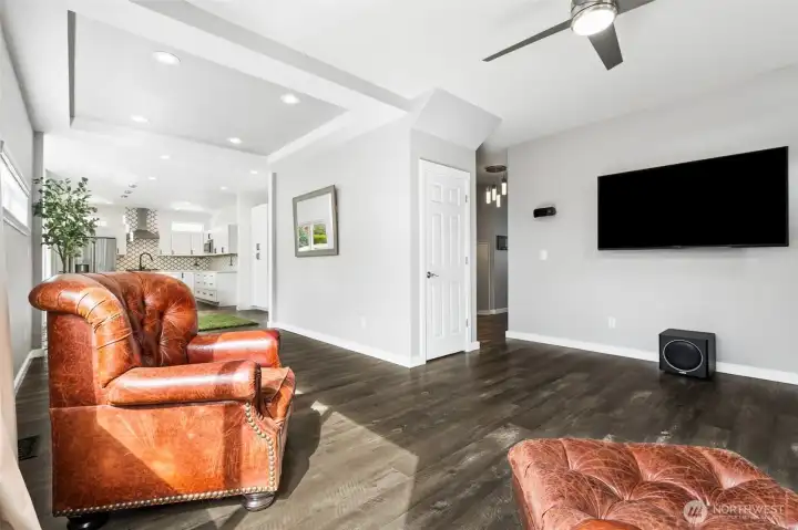 Sightlines run clean from the living room straight into the dining area and kitchen, with the bedroom wing and front entry clearly defined off the hallway. Right in the center, a deep storage closet steps in and quietly solves a lot of real-life problems. The dining space gets its own moment with a tray ceiling detail that frames it without boxing it in. And no chandelier dictating your table placement here, recessed lighting keeps the ceiling clean and gives you total freedom to use the space your way.