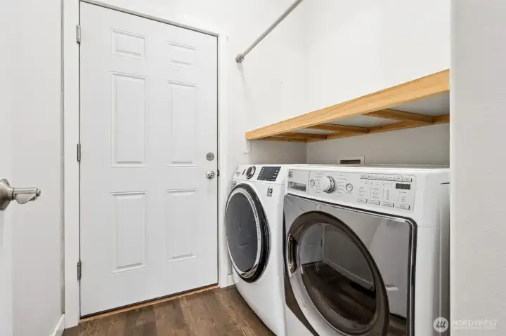 Positioned right off the garage, the laundry room catches any mess before it tracks through the house. You’ve got a high-efficiency washer and dryer included, a sturdy shelf that can handle the real stuff, and a hanging bar that keeps things moving without piling up. But the real win here is in the layout. Placed between two bedrooms, this space acts like a built-in buffer, giving each room a little extra breathing room and a lot more privacy.
