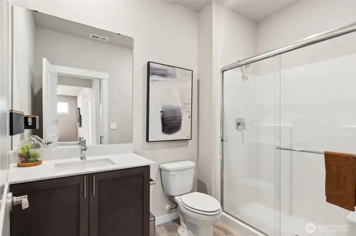 Spacious main floor bathroom with showerPhoto's are for representational purposes only. Colors and finishes may differ..