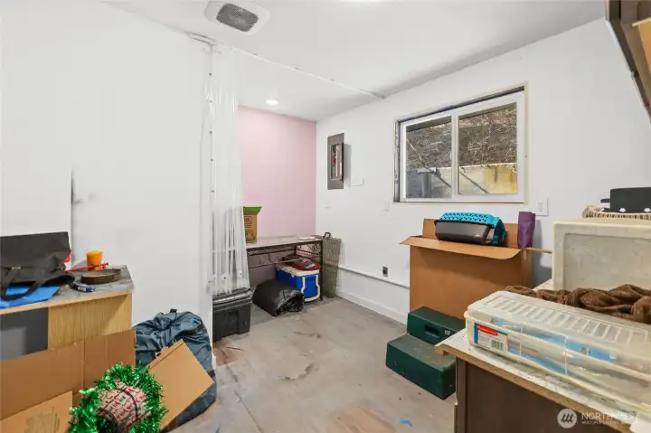 Second of 2 bonus rooms off of garage, perfect for home office, studio, or craft room.