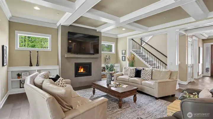 Incredible “heart of the home” great room features lofty 10’ box beam ceilings, a contemporary gas fireplace with LED lighting and decorative tile, built-in shelving and a concealed media conduit. Incredible “heart of the home” great room features lofty 10’ box beam ceilings, a contemporary gas fireplace with LED lighting and decorative tile, built-in shelving and a concealed media conduit.