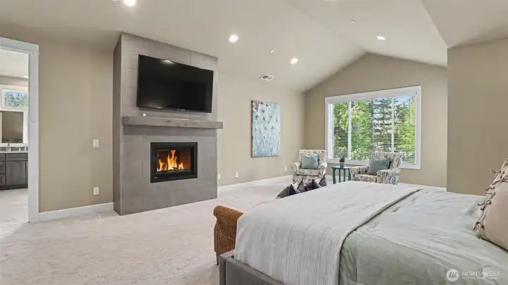 Luxurious master suite rivals a 5 star resort with a vaulted ceiling, sitting area with a gas fireplace and views of nature plus 2 generous custom walk-in closets: one with a built-in storage island. Luxurious master suite rivals a 5 star resort with a vaulted ceiling, sitting area with a gas fireplace and views of nature plus 2 generous custom walk-in closets: one with a built-in storage island.