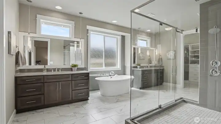 Frameless shower features a rainfall and shower head combination. His and her custom walk-in closets with built-in drawers and shelving. Frameless shower features a rainfall and shower head combination. His and her custom walk-in closets with built-in drawers and shelving.