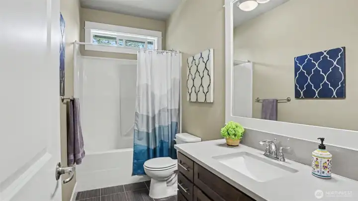 Warm tile floors, quartz counter, under-mount sink, and tub/shower combination included in the junior suite Warm tile floors, quartz counter, under-mount sink, and tub/shower combination included in the junior suite