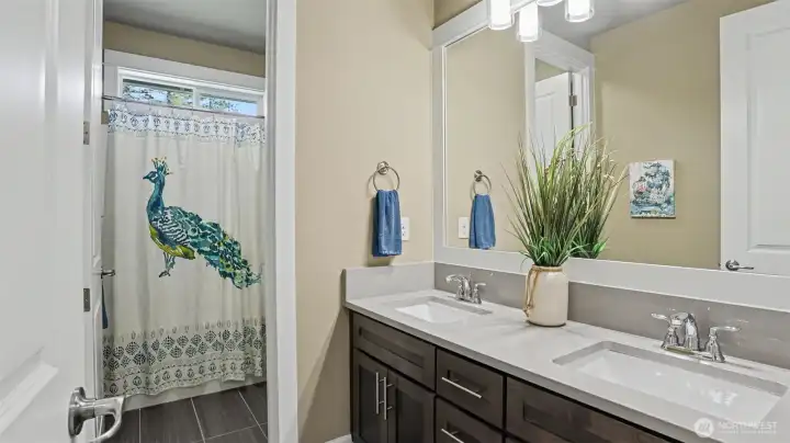 Upper level full bath with dual vanities and separate shower/tub area for added privacy. Upper level full bath with dual vanities and separate shower/tub area for added privacy.