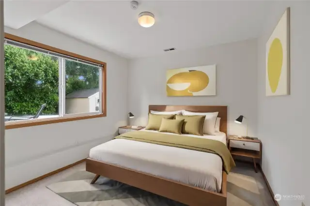 Fifth bedroom downstairs with a serene treed view.