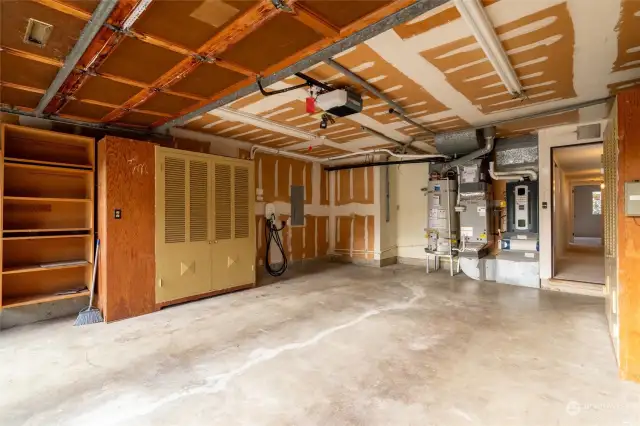 2 car garage with storage. There is a newer heat pump for heating and cooling. When temperatures fall below 30 degrees they trigger an automatic shift to the gas furnace. EV charger is not visible in this photo.