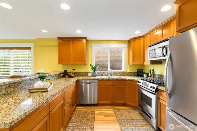 Gas cooking and French-style refrigerator with bottom freezer.