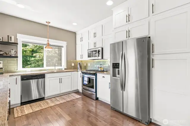 Stunning kitchen overlooks the private backyard.