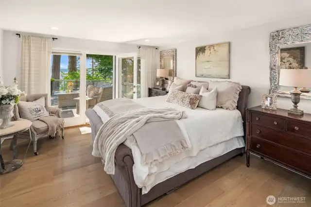 Primary bedroom on the main level also has French doors leading to the deck.