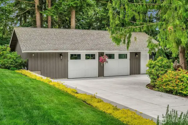 Two car garage with attached storage area to the left and sitting room to the right.