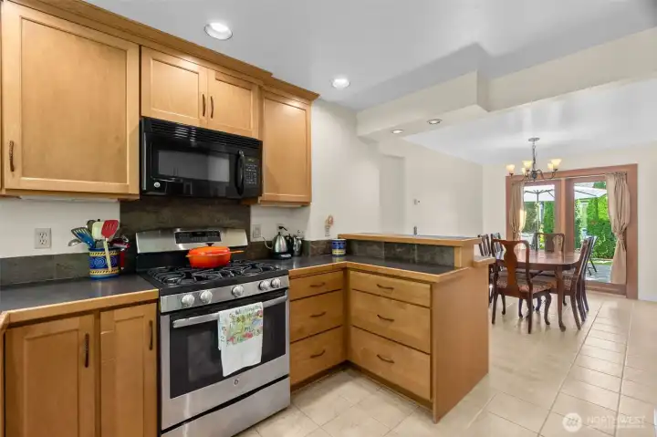 Recessed lighting ensure a bright kitchen for cooking and sharing, while the bar counter offers a space to visit and connect.
