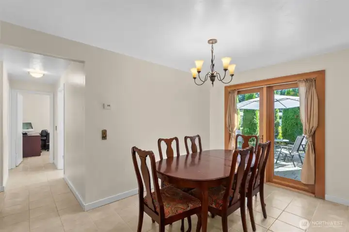 Not to be over-highlighted, the glass atrium door here brings in the beauty and light of nature to the kitchen and dining room, and creates a wonderful flow to the outdoors. The hallway on the left continues to the bedrooms...