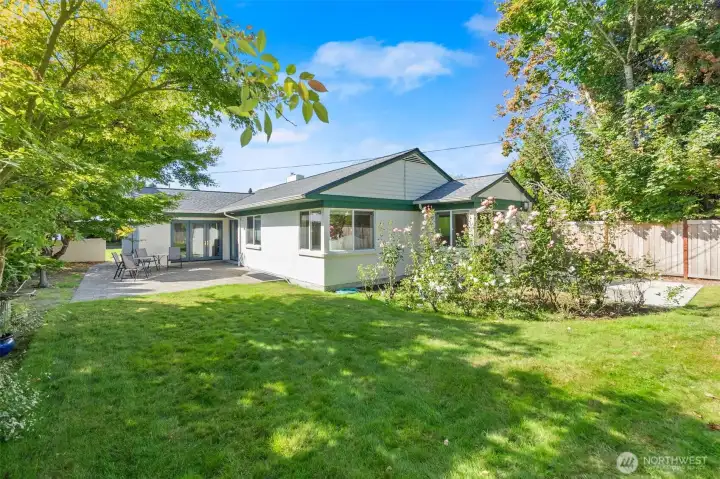 If you're not in love yet, the backyard will have you grinning from ear to ear! Lush grass, beautiful rose gardens and ample patio space mean many sweet mornings, afternoons, and evenings spent enjoying this view.